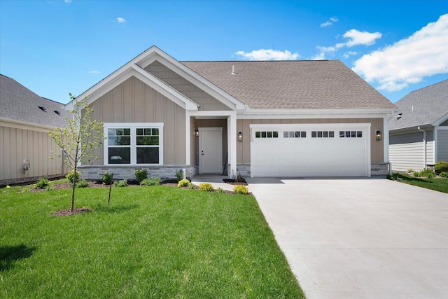 2300 Old Bridge Ln, Hastings, MN 55033 - view of front facade with an attached garage, concrete driveway, a front yard, board and batten siding, and a shingled roof