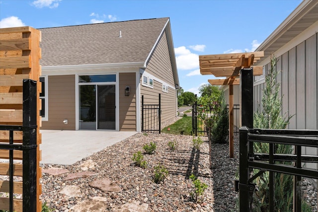 2300 Old Bridge Ln, Hastings, MN 55033 - view of home's exterior featuring a patio, a shingled roof, and a gate