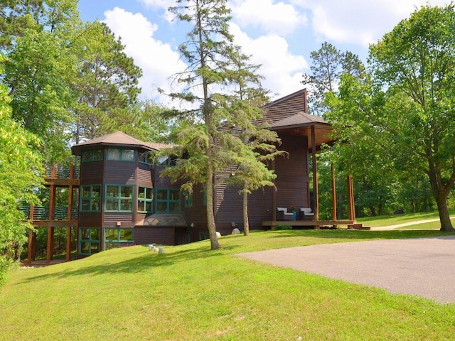 27620 Island View Dr, Park Rapids, MN 56470 - view of grassy yard featuring a deck and a sunroom