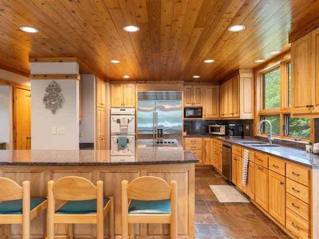 27620 Island View Dr, Park Rapids, MN 56470 - kitchen featuring built in appliances, a sink, recessed lighting, wood ceiling, and a kitchen bar