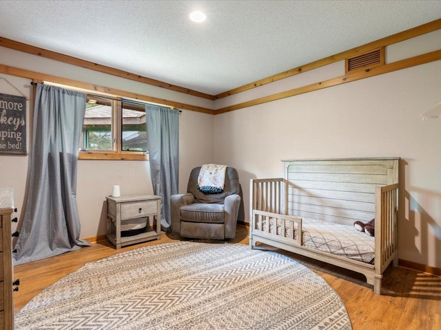 27620 Island View Dr, Park Rapids, MN 56470 - bedroom with wood finished floors, baseboards, a textured ceiling, and recessed lighting