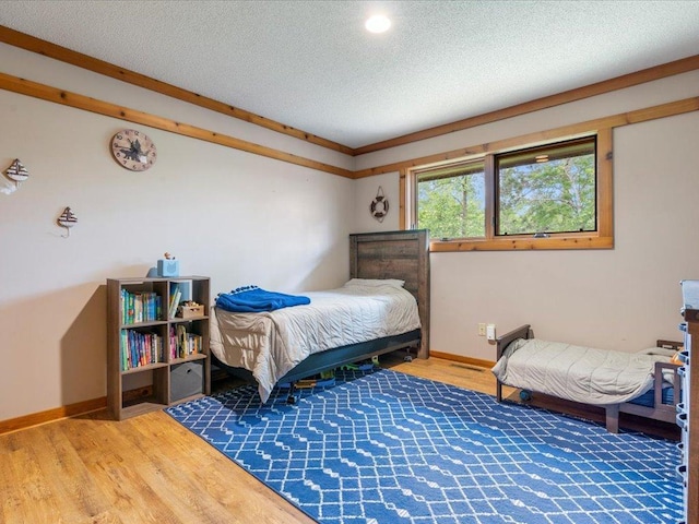 27620 Island View Dr, Park Rapids, MN 56470 - bedroom with wood finished floors, a textured ceiling, and baseboards