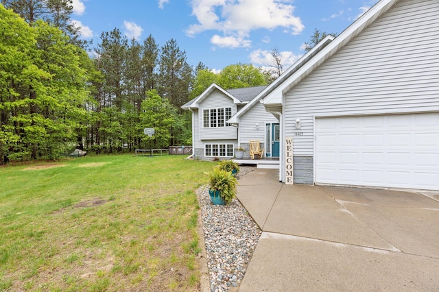 14465 Blackberry Ct, Baxter, MN 56425 - view of grassy yard with concrete driveway and a garage