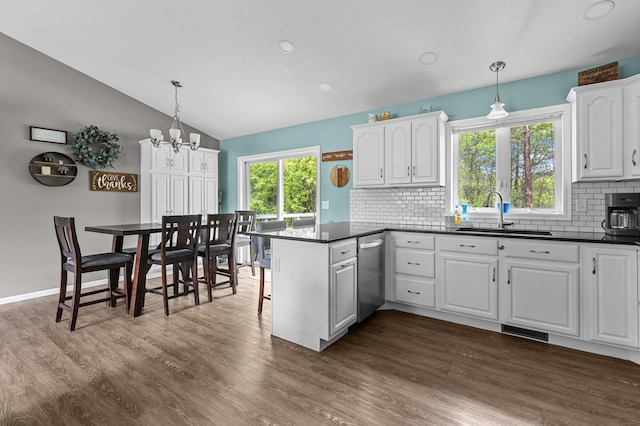 14465 Blackberry Ct, Baxter, MN 56425 - kitchen with a sink, dark countertops, a peninsula, dishwasher, and lofted ceiling