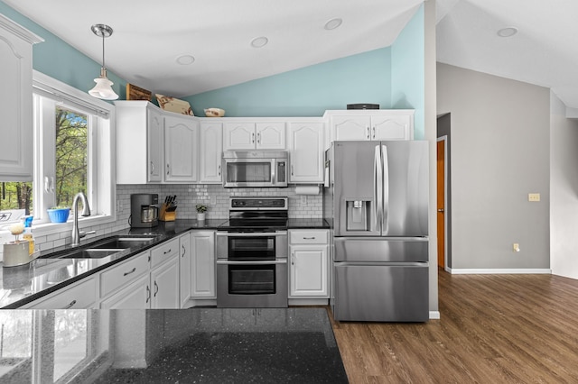 14465 Blackberry Ct, Baxter, MN 56425 - kitchen with appliances with stainless steel finishes, a sink, lofted ceiling, white cabinets, and backsplash