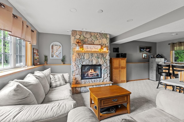 14465 Blackberry Ct, Baxter, MN 56425 - living area featuring a stone fireplace, baseboards, and carpet flooring