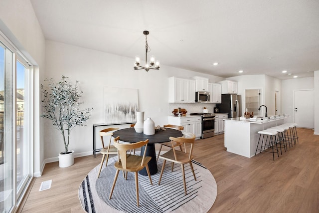 6570 Jody Ave S, Cottage Grove, MN 55016 - dining area featuring a chandelier, light wood-style floors, recessed lighting, and baseboards