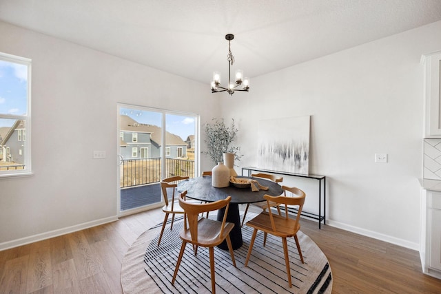 6570 Jody Ave S, Cottage Grove, MN 55016 - dining room with a chandelier, wood finished floors, and baseboards