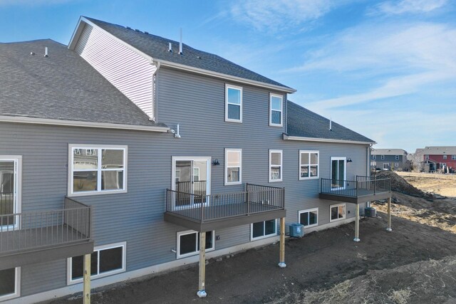 6570 Jody Ave S, Cottage Grove, MN 55016 - back of house featuring central AC unit, roof with shingles, and a balcony