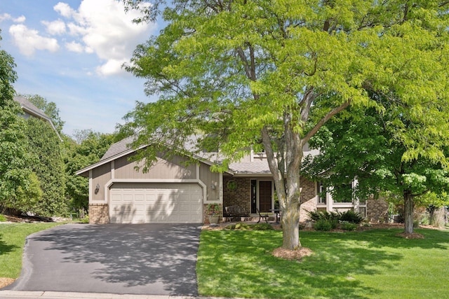 4650 Cottonwood Ln N, Plymouth, MN 55442 - obstructed view of property with brick siding, driveway, a front yard, and a garage