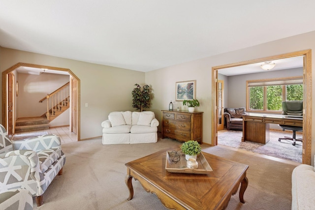 4650 Cottonwood Ln N, Plymouth, MN 55442 - living area featuring light colored carpet, stairway, arched walkways, and an office area