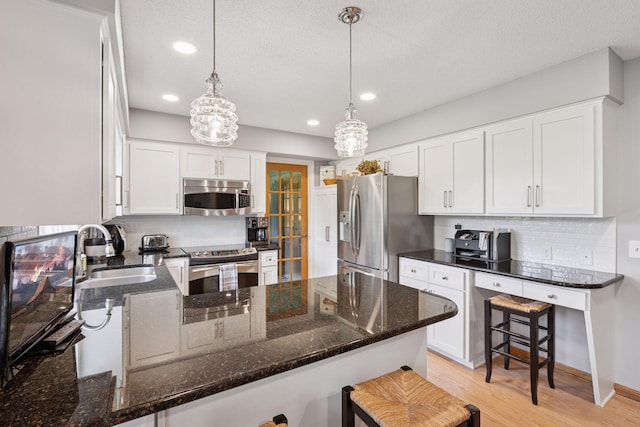 4650 Cottonwood Ln N, Plymouth, MN 55442 - kitchen featuring stainless steel appliances, a peninsula, tasteful backsplash, dark stone countertops, and recessed lighting
