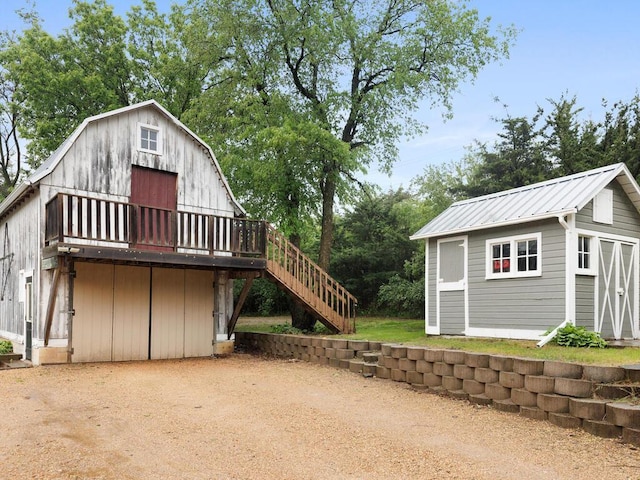 601 Kingsway Dr, Le Sueur, MN 56058 - view of side of home featuring an outbuilding, stairs, a barn, a garage, and metal roof