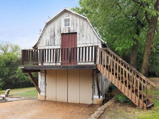 601 Kingsway Dr, Le Sueur, MN 56058 - back of property featuring stairs, a deck, and a barn