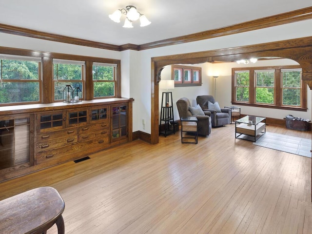 601 Kingsway Dr, Le Sueur, MN 56058 - living room with plenty of natural light, wood-type flooring, a chandelier, and crown molding