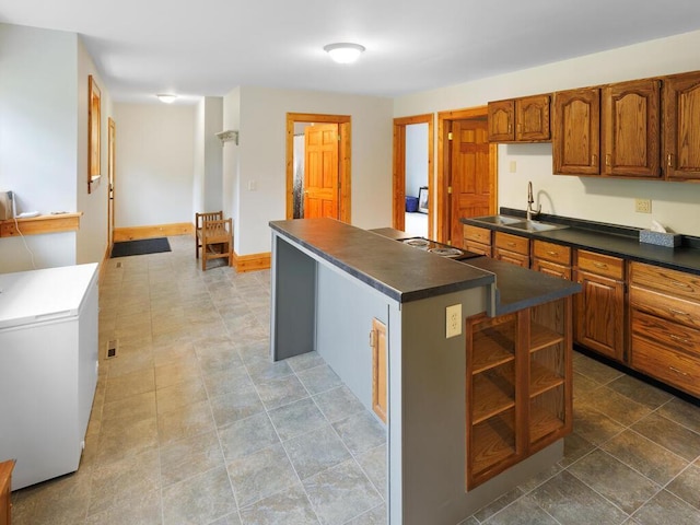 601 Kingsway Dr, Le Sueur, MN 56058 - kitchen featuring white fridge, a sink, dark countertops, and a center island