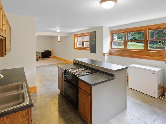 601 Kingsway Dr, Le Sueur, MN 56058 - kitchen featuring black electric range oven, fridge, a sink, dark countertops, and light tile patterned floors