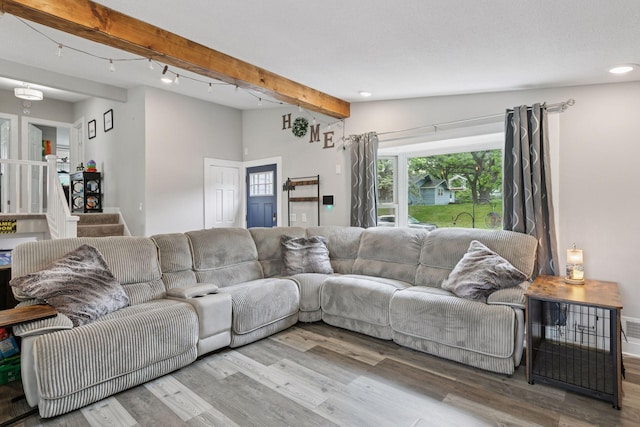 living room with beam ceiling, wood finished floors, recessed lighting, and baseboards