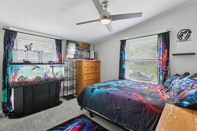 bedroom featuring lofted ceiling, carpet, a textured ceiling, and ceiling fan