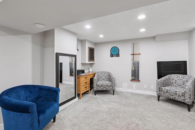 sitting room featuring light carpet, baseboards, and recessed lighting
