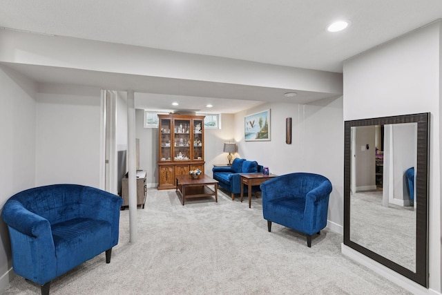 living area featuring light carpet, recessed lighting, and baseboards