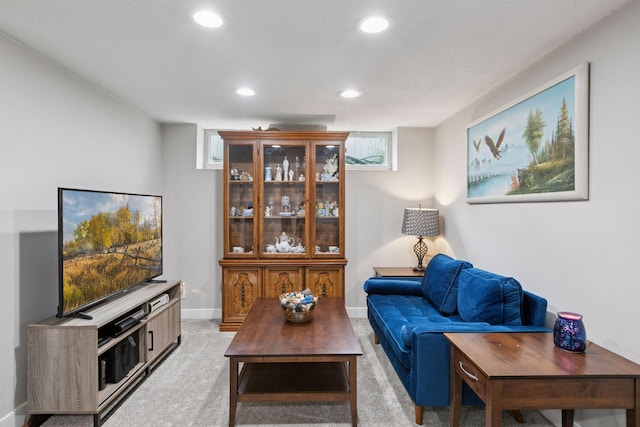living room with recessed lighting, light carpet, and baseboards