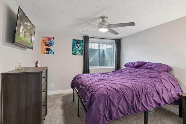 bedroom with dark colored carpet, a textured ceiling, a ceiling fan, and baseboards