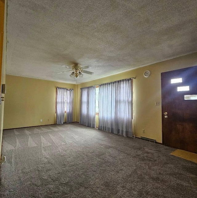701 10th St NE, Austin, MN 55912 - carpeted spare room with a textured ceiling and a ceiling fan