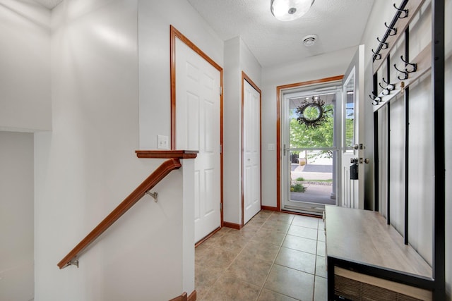 5133 Farnham Dr N, Hugo, MN 55038 - entrance foyer with baseboards, a textured ceiling, and light tile patterned floors