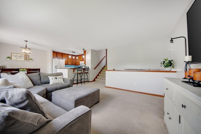 5133 Farnham Dr N, Hugo, MN 55038 - living room featuring light carpet, a chandelier, stairs, and baseboards