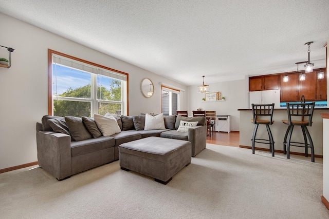 5133 Farnham Dr N, Hugo, MN 55038 - living area with light carpet, a textured ceiling, and baseboards