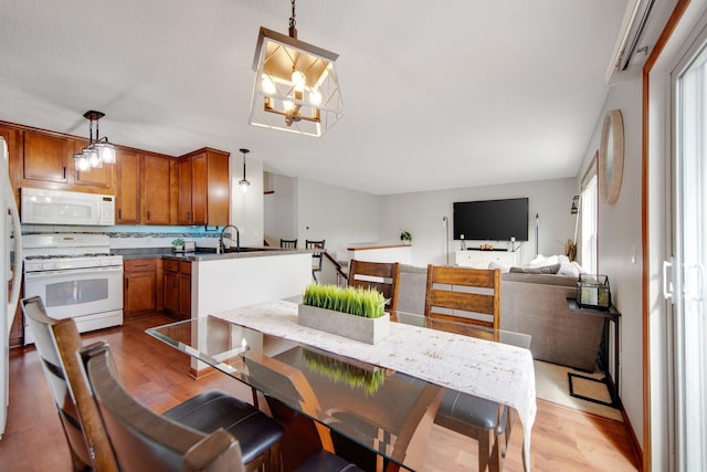 5133 Farnham Dr N, Hugo, MN 55038 - dining room featuring light wood finished floors and a chandelier