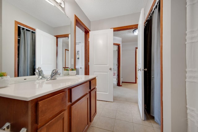 5133 Farnham Dr N, Hugo, MN 55038 - bathroom with a textured ceiling, tile patterned flooring, and vanity
