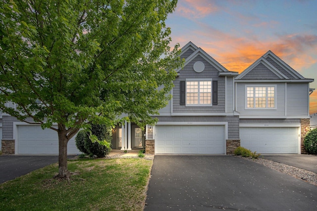 5133 Farnham Dr N, Hugo, MN 55038 - view of front of house with stone siding, driveway, and an attached garage