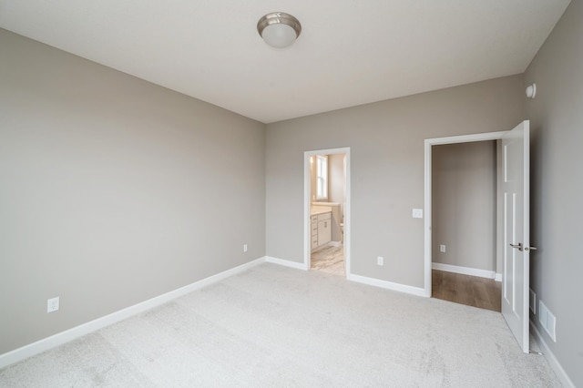 4963 Janura Way, Saint Michael, MN 55376 - unfurnished bedroom with light colored carpet, baseboards, and ensuite bathroom