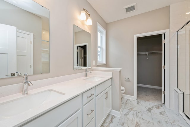 4963 Janura Way, Saint Michael, MN 55376 - bathroom featuring toilet, double vanity, marble finish floors, tiled shower, and a spacious closet