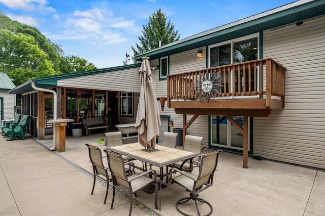 2511 Carver Ave E, Maplewood, MN 55119 - view of patio featuring outdoor dining space, a deck, and a sunroom