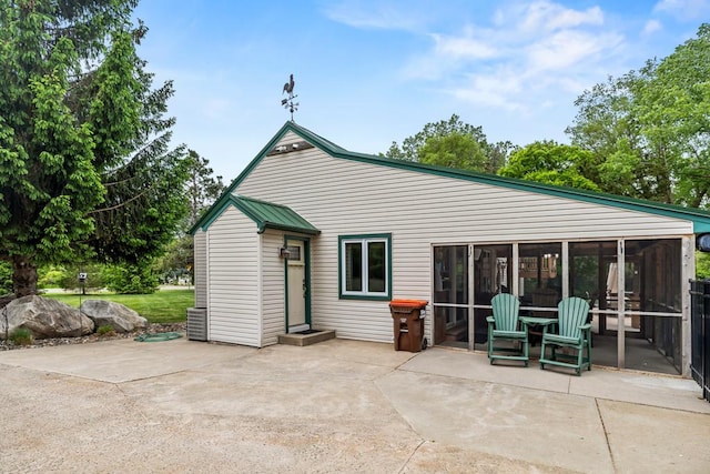 2511 Carver Ave E, Maplewood, MN 55119 - back of house featuring a sunroom and a patio