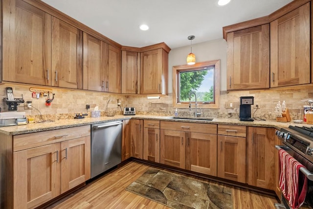 2511 Carver Ave E, Maplewood, MN 55119 - kitchen featuring a sink, stainless steel dishwasher, stove, light wood-style flooring, and decorative backsplash