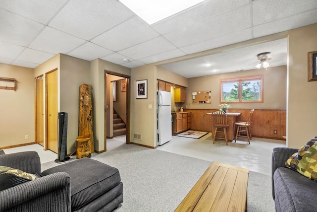 2511 Carver Ave E, Maplewood, MN 55119 - living room featuring a drop ceiling, stairs, and light carpet