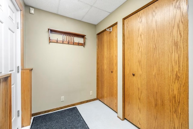 2511 Carver Ave E, Maplewood, MN 55119 - unfurnished bedroom with multiple closets, a paneled ceiling, and baseboards