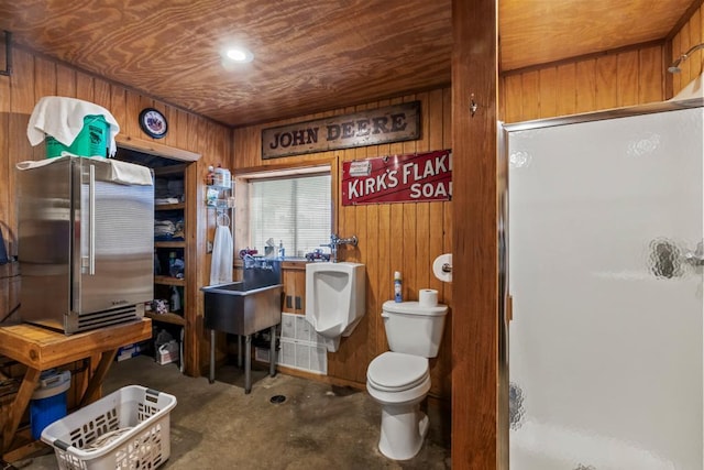 2511 Carver Ave E, Maplewood, MN 55119 - full bath with a stall shower, wood walls, toilet, and concrete floors