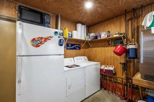 2511 Carver Ave E, Maplewood, MN 55119 - laundry room featuring washing machine and dryer and wooden walls