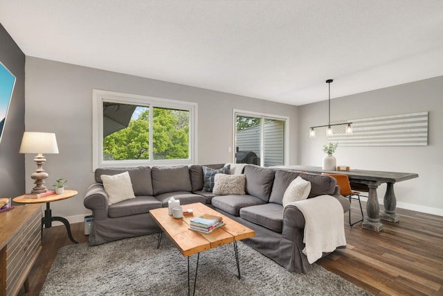 4119 Sylvia Ln S, Shoreview, MN 55126 - living area with baseboards, dark wood-style floors, and a chandelier