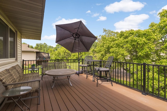 4119 Sylvia Ln S, Shoreview, MN 55126 - wooden terrace with outdoor dining space and view of wooded area