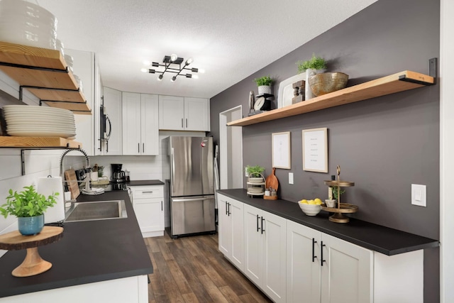 4119 Sylvia Ln S, Shoreview, MN 55126 - kitchen featuring freestanding refrigerator, open shelves, dark countertops, a sink, and white cabinets
