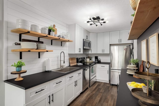 4119 Sylvia Ln S, Shoreview, MN 55126 - kitchen with stainless steel appliances, open shelves, a sink, dark countertops, and dark wood-style floors