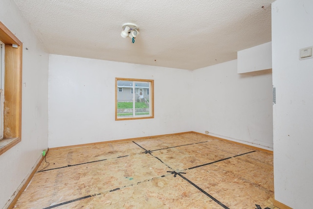 205 Elm Ave SE, Montgomery, MN 56069 - empty room featuring a textured ceiling and baseboards