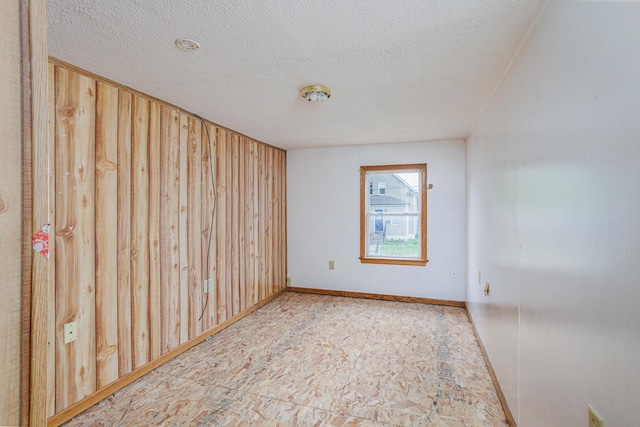 205 Elm Ave SE, Montgomery, MN 56069 - empty room featuring a textured ceiling and baseboards