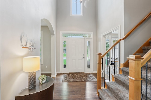 11560 Ashley Ct, Inver Grove Heights, MN 55077 - foyer entrance featuring healthy amount of natural light, arched walkways, wood finished floors, a towering ceiling, and stairway